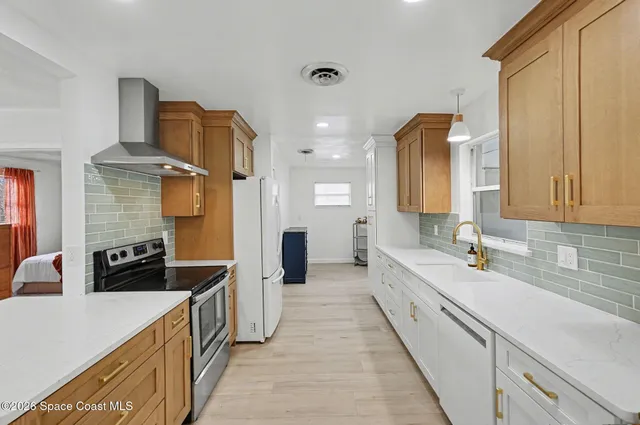 a large white kitchen with a large window