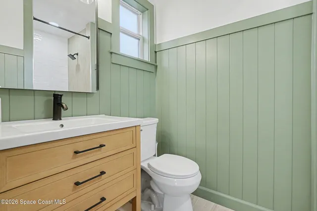 a bathroom with a sink a toilet and vanity