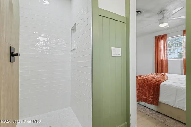 a bedroom with a bed and a mirror