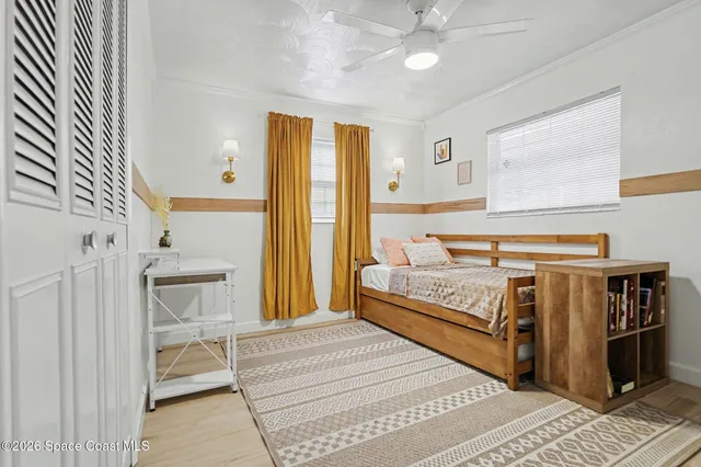 a bedroom with a bed and a large window