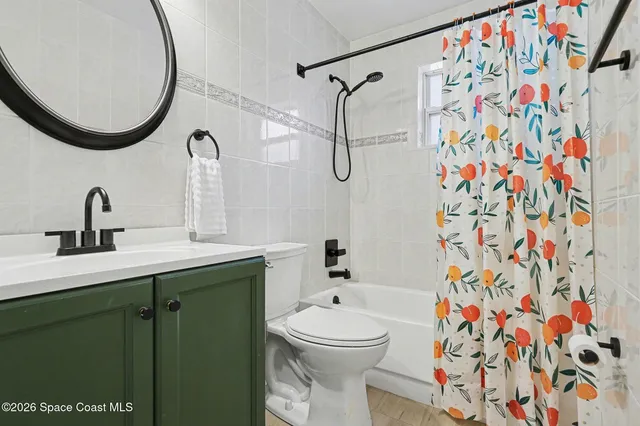 a bathroom with a sink a toilet and shower curtain