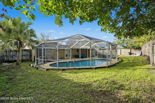 a view of a house with a yard patio and a garden