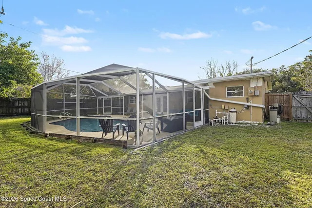 a view of a house with a yard and sitting area