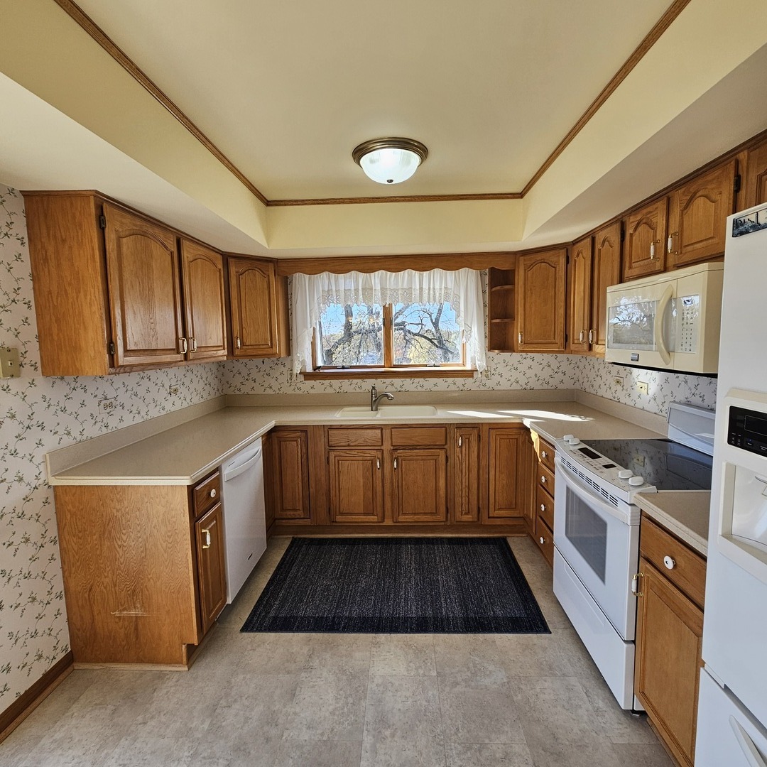 3620 186th Street, Unit 405 Lansing, IL 60438 - Photo 13 of 36 a kitchen with a sink stove and microwave