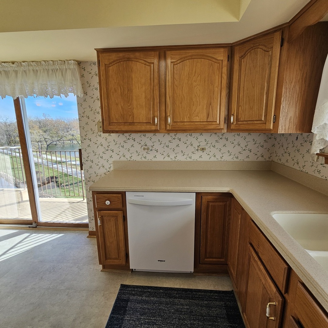 3620 186th Street, Unit 405 Lansing, IL 60438 - Photo 14 of 36 a kitchen with a sink cabinets and wooden floor