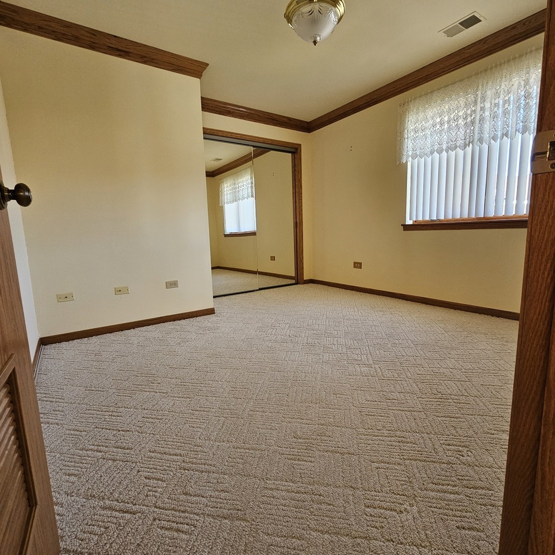 3620 186th Street, Unit 405 Lansing, IL 60438 - Photo 20 of 36 a view of an empty room with a window