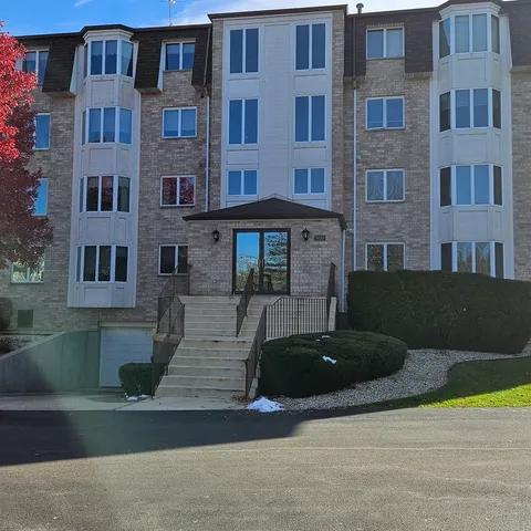 a front view of a building with parking space