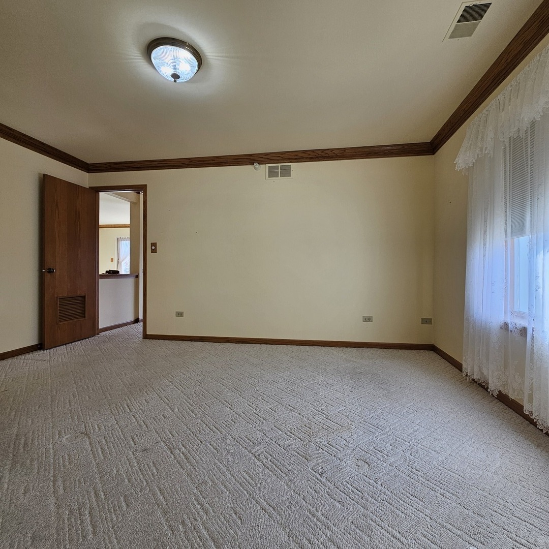 3620 186th Street, Unit 405 Lansing, IL 60438 - Photo 29 of 36 an empty room with wooden floor and windows
