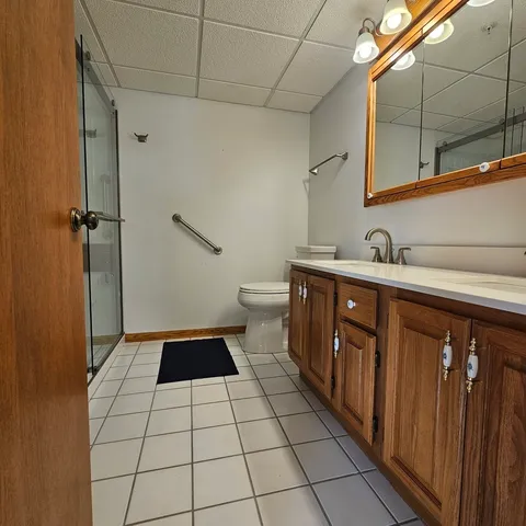 a bathroom with a glass shower door