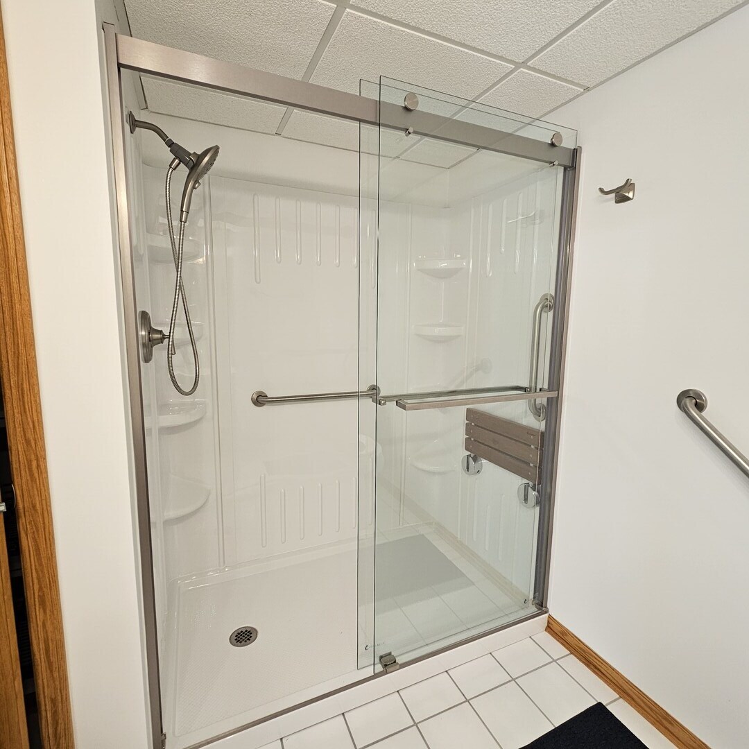 3620 186th Street, Unit 405 Lansing, IL 60438 - Photo 32 of 36 a bathroom with a glass shower door