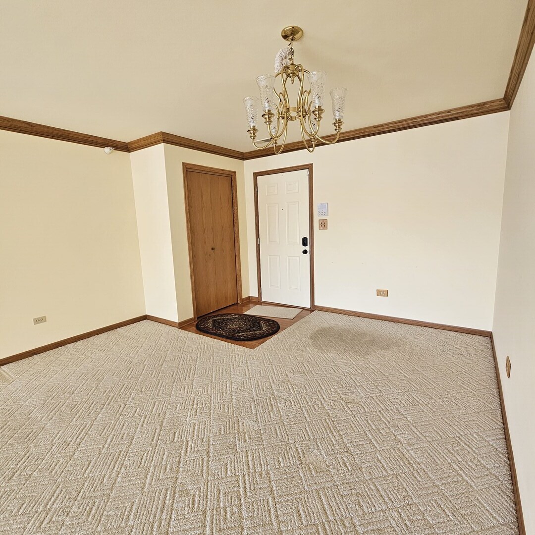 3620 186th Street, Unit 405 Lansing, IL 60438 - Photo 5 of 36 a view of a room with wooden floor and a chandelier