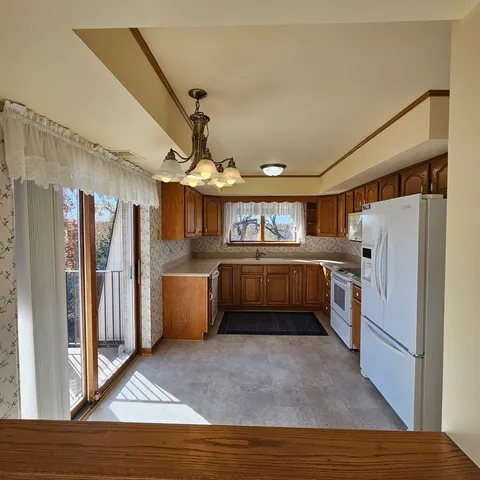 a kitchen with refrigerator cabinets and wooden floor