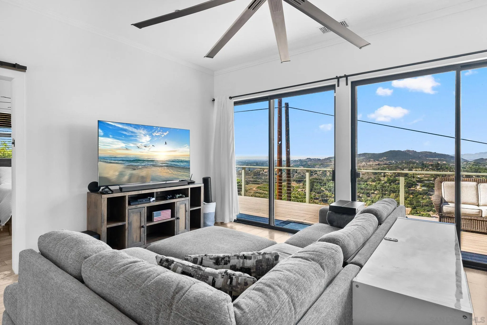 5521 Rainbow Heights Road Fallbrook, CA 92028 - Photo 13 of 36 a living room with furniture large windows and a flat screen tv