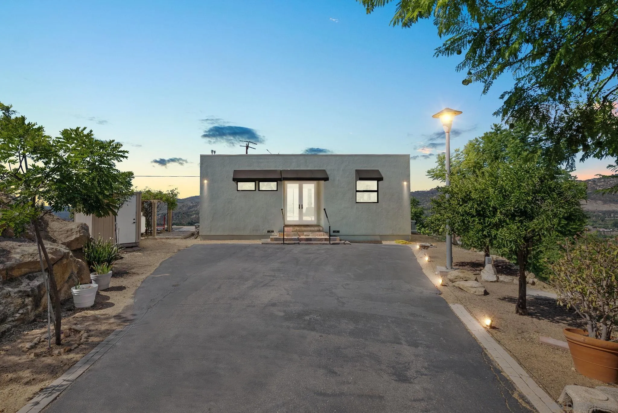 5521 Rainbow Heights Road Fallbrook, CA 92028 - Photo 2 of 36 a front view of a house with a yard and garage