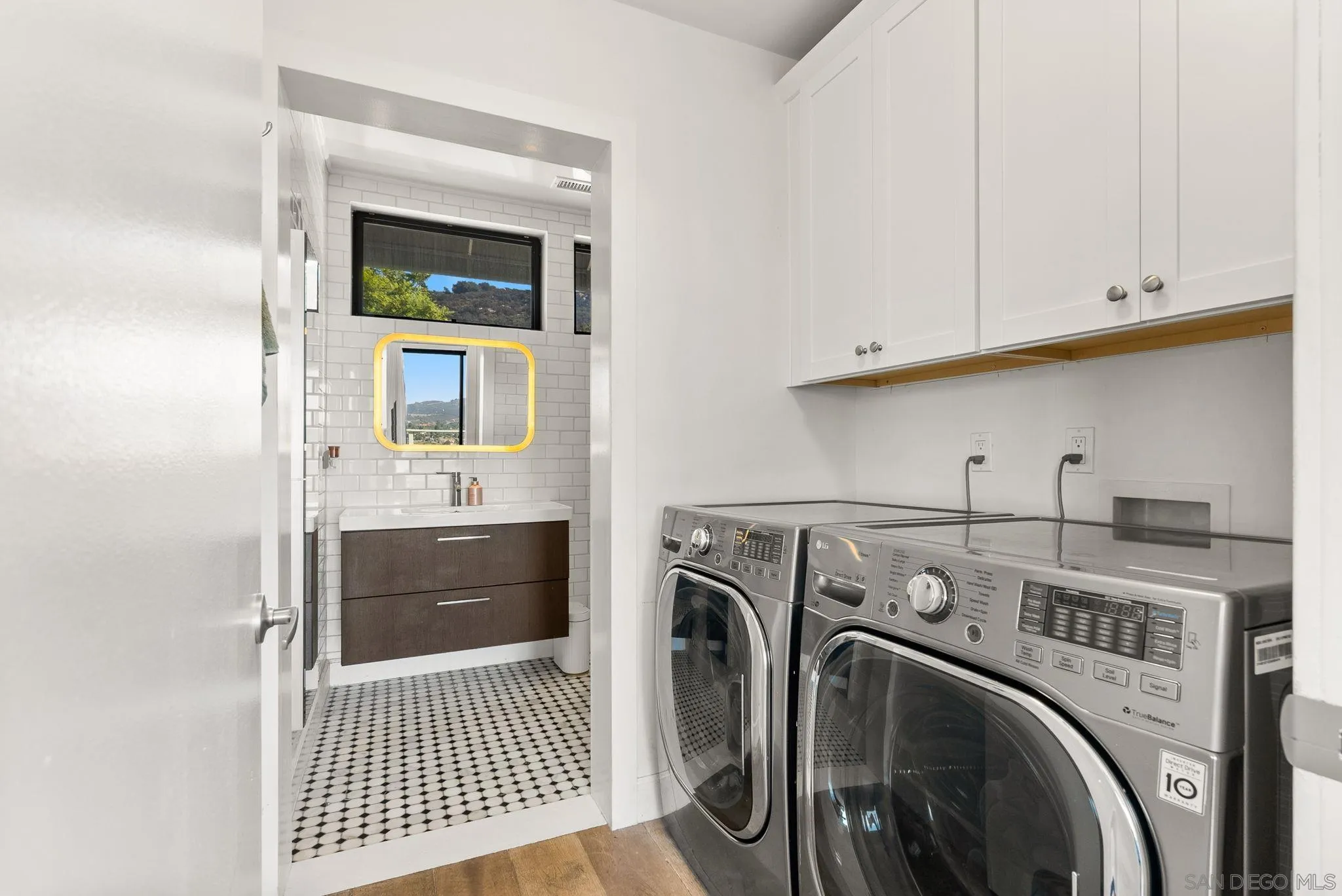 5521 Rainbow Heights Road Fallbrook, CA 92028 - Photo 26 of 36 a view of washer and dryer with kitchen in the background