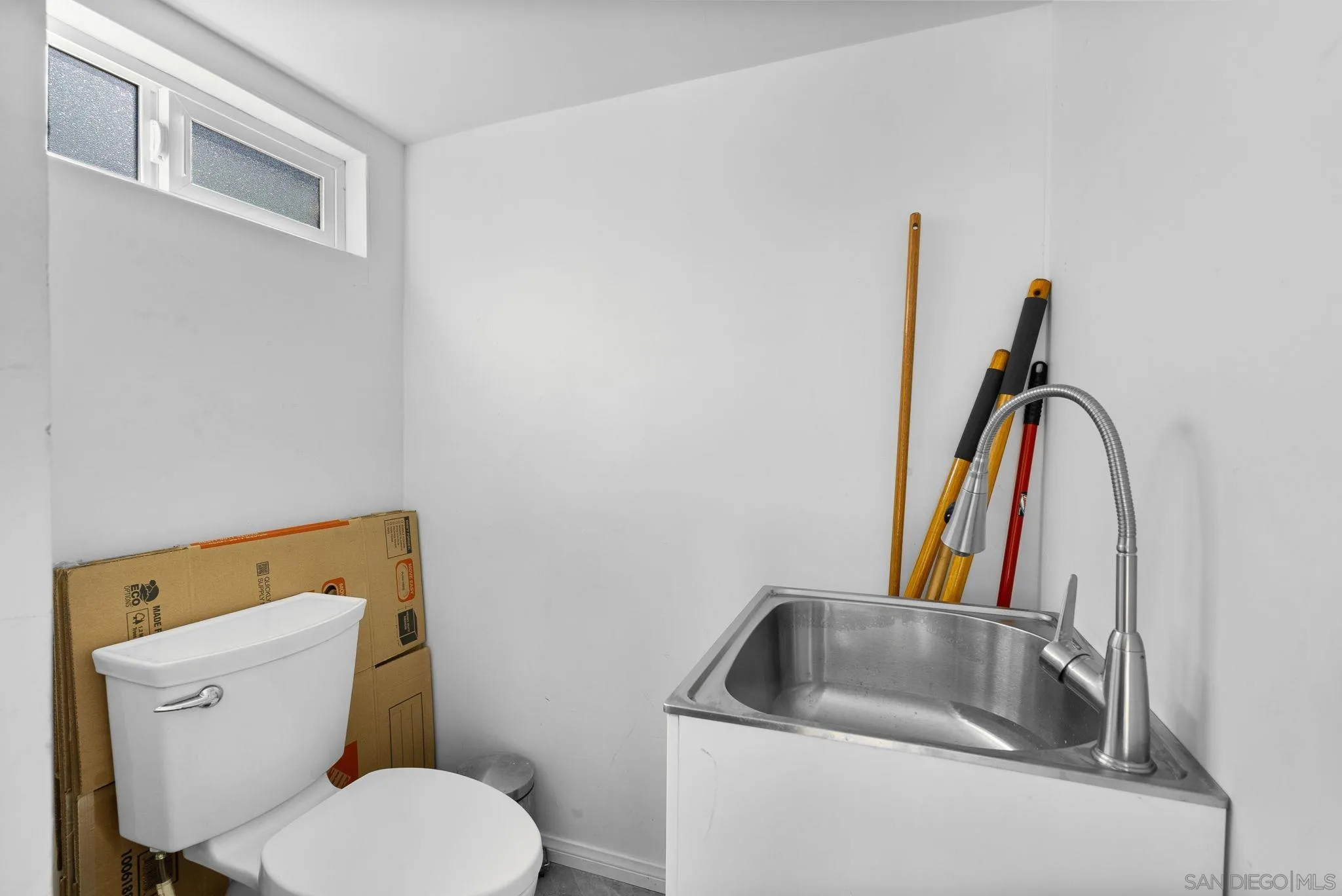 5521 Rainbow Heights Road Fallbrook, CA 92028 - Photo 32 of 36 a bathroom with a toilet sink and mirror