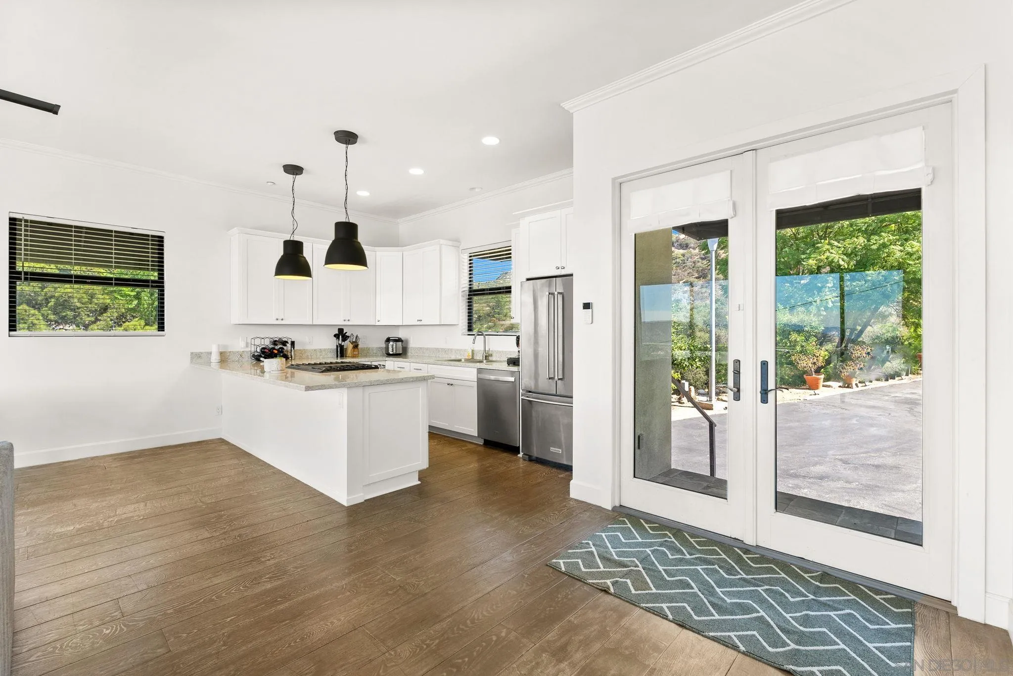 5521 Rainbow Heights Road Fallbrook, CA 92028 - Photo 7 of 36 a kitchen with a refrigerator and white cabinets