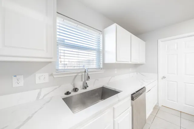 a kitchen with a sink cabinets and window