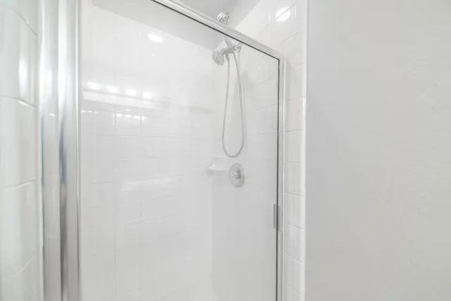 a bathroom with a glass shower door