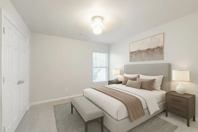 a bedroom with a bed and a window