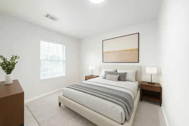 a bedroom with a bed and a potted plant