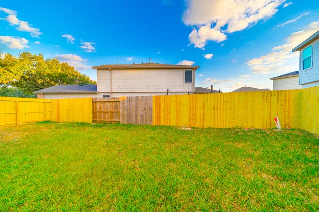 a view of swimming pool with table and chairs