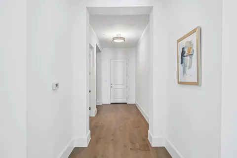 a view of a hallway with wooden floor