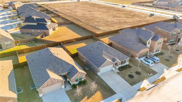 an aerial view of residential houses with outdoor space