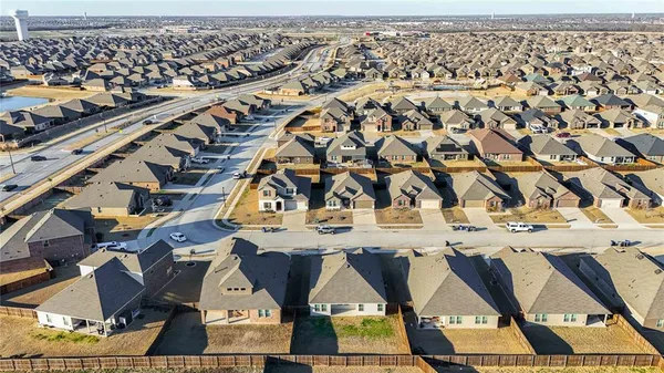 an aerial view of a residential building and parking space