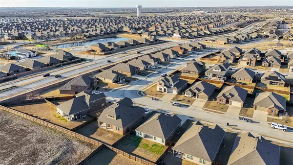 an aerial view of a residential building with parking