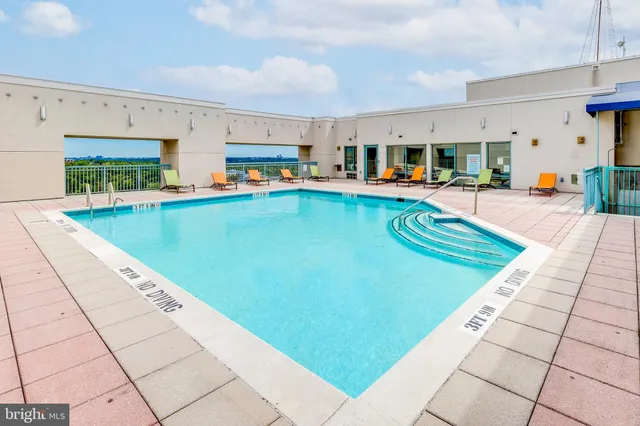 a view of a swimming pool with outdoor seating