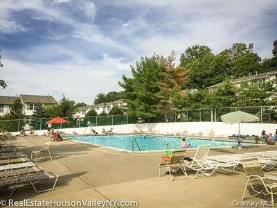 a view of a swimming pool and a yard