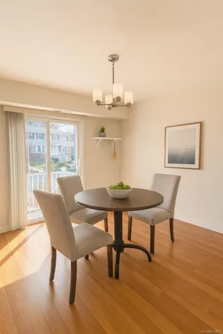 a view of a dining room with furniture window and wooden floor