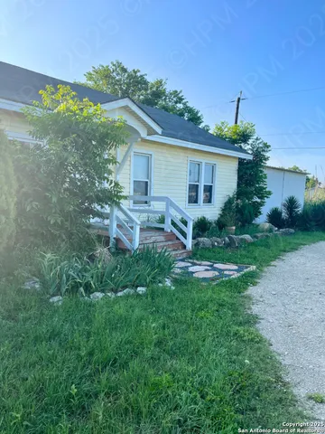a view of a house with a backyard and a patio
