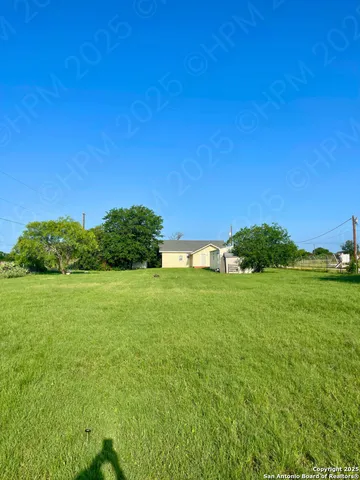 a view of a field of grass and trees