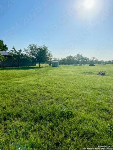 a view of a field with an ocean