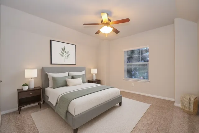 a bedroom with a bed and a window