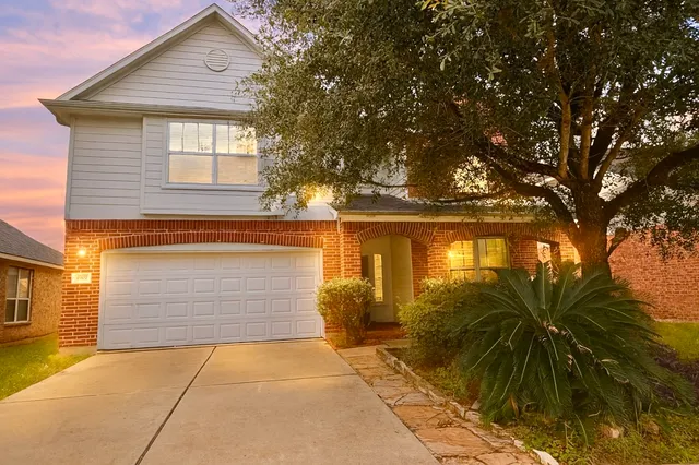 a front view of house with yard and trees around