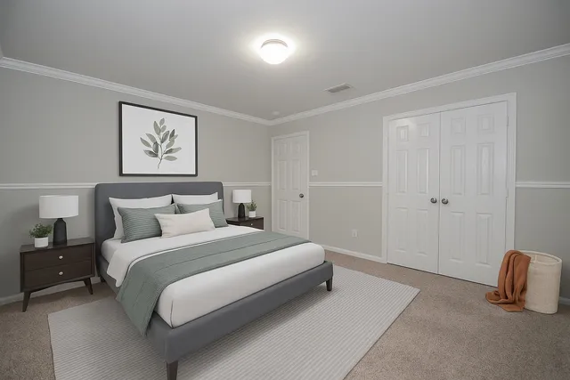 a bedroom with a bed and a lamp