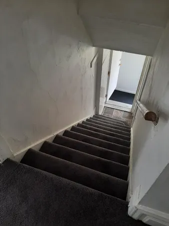 a view of an empty room and a window