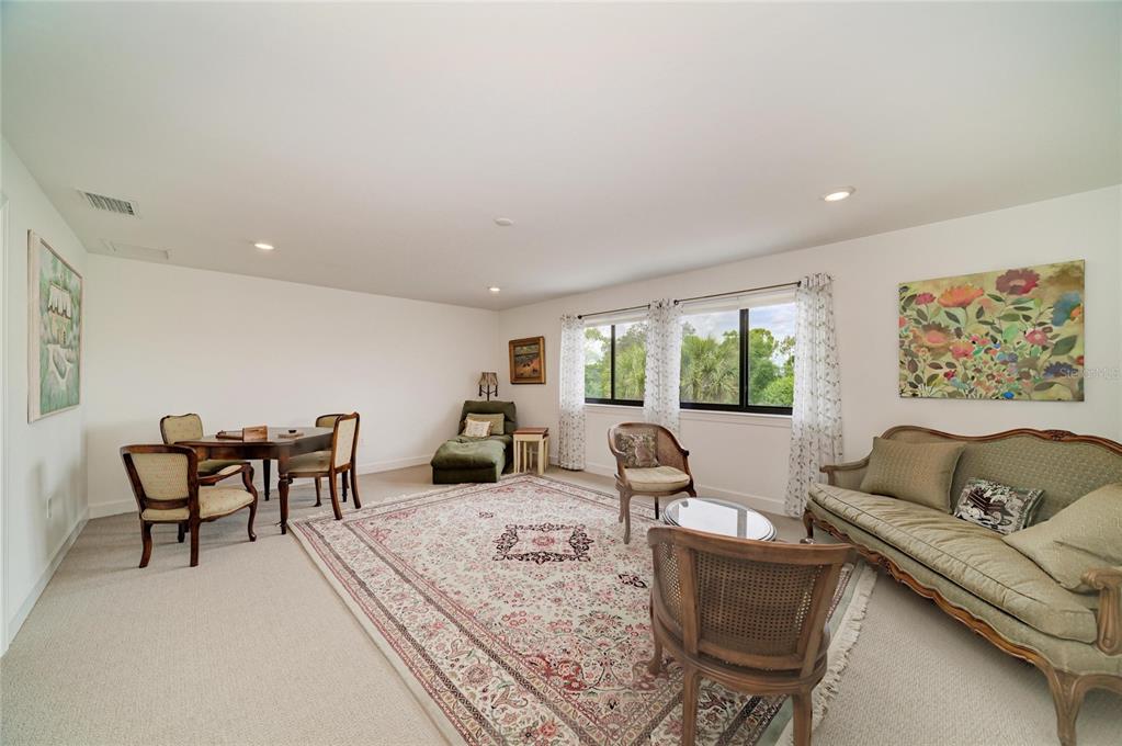 16341 Hidden Oak Loop Lakewood Ranch, FL 34211 - Photo 46 of 76 a living room with furniture and a large window