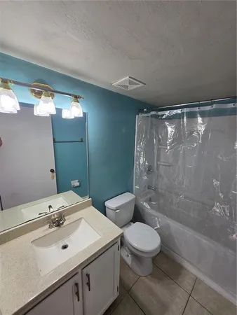 a bathroom with a toilet a sink and a mirror