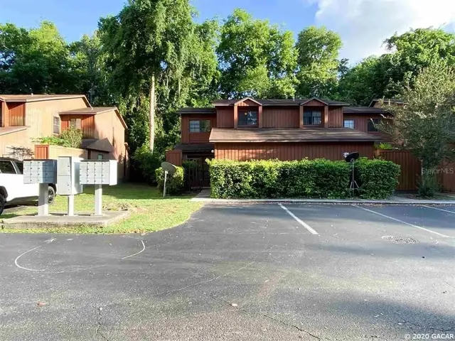 a view of a house with a yard and plants