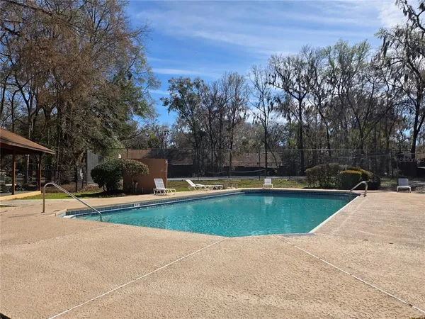 a view of outdoor space yard swimming pool and trees