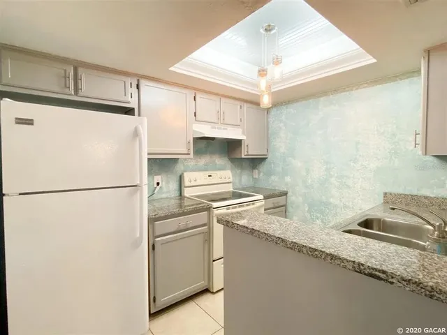 a white refrigerator freezer sitting inside of a kitchen