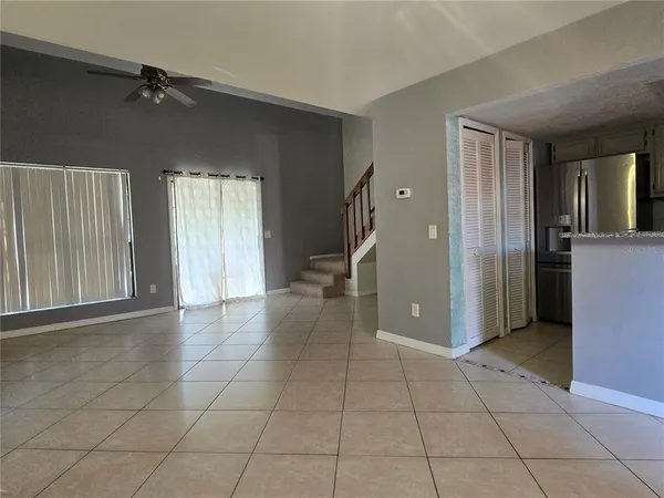 a view of a hallway with closet and a livingroom view