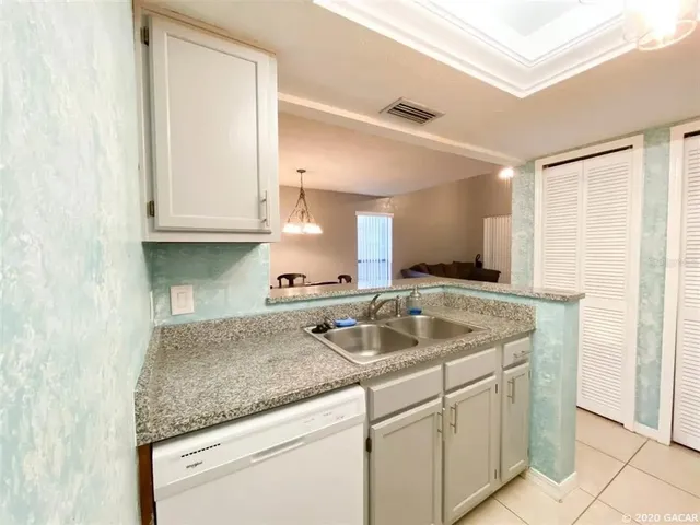 a kitchen with granite countertop a sink and a stove