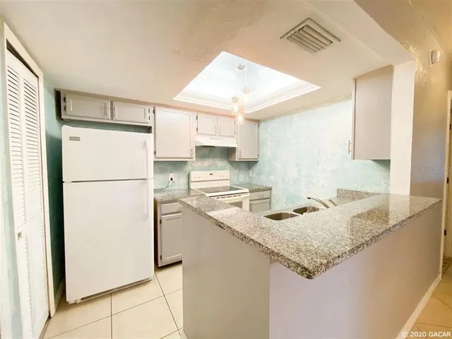 a kitchen with a refrigerator a sink and a refrigerator