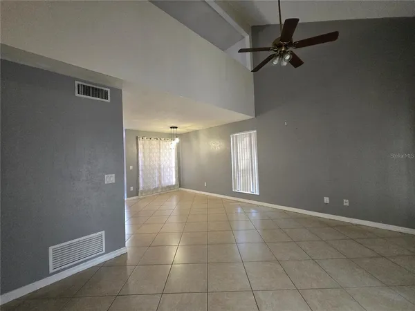 a view of a livingroom with a ceiling fan and window