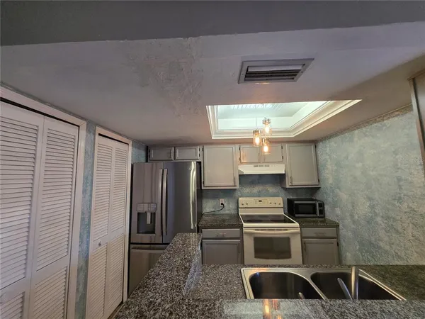 a kitchen with a stove and a refrigerator